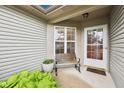Inviting front porch with a bench, potted plants, and a welcoming front door at 12207 Blue Sky Dr, Fishers, IN 46037