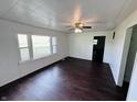 Bright living room featuring hardwood floors, a ceiling fan, and large windows at 1445 S 750 W, Shelbyville, IN 46176