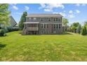 Spacious backyard featuring a well-maintained lawn and a screened-in porch, ideal for outdoor gatherings at 15047 Glenmoor Cir, Carmel, IN 46033