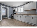 Bright kitchen with white cabinets, stainless steel appliances, and butcher block countertops at 1529 E Tabor St, Indianapolis, IN 46203
