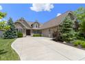 Beautiful brick home featuring a spacious driveway, manicured lawn, and mature trees at 16550 Gleneagles Ct, Noblesville, IN 46060