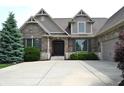 Beautiful brick home featuring a double door entry, manicured landscaping and concrete driveway at 16550 Gleneagles Ct, Noblesville, IN 46060