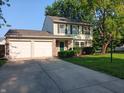 Inviting two-story home with a spacious two-car garage and a well-kept front lawn at 18851 Wimbley Way, Noblesville, IN 46060