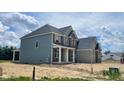 New two-story home featuring a mix of stone, siding, and brick exterior finishes, enhanced by an inviting covered front porch at 1919 Delp Ct, Avon, IN 46123