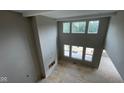 Spacious living room with soaring ceilings, ample natural light from large windows, and a cozy fireplace at 1919 Delp Ct, Avon, IN 46123