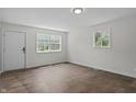 Bedroom showcasing hardwood floors, fresh white paint, and lots of natural light at 1948 Bloyd Ave, Indianapolis, IN 46218