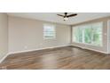 Spacious living room featuring hardwood floors, a ceiling fan, and ample natural light at 2925 E 8Th St, Anderson, IN 46012