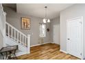Inviting entryway with wood-look floors, a staircase, and a front door, providing a warm welcome at 3011 N New Jersey St, Indianapolis, IN 46205