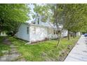 Charming home boasts mature trees, side porch, and well-maintained landscaping, offering great curb appeal at 307 E 5Th St, Sheridan, IN 46069