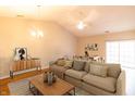 Bright living room featuring hardwood floors, a vaulted ceiling, and contemporary furnishings at 4291 Washington Blvd, Plainfield, IN 46168