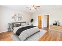 Relaxing bedroom with a ceiling fan, hardwood floors, and modern decor with neutral color palette at 4291 Washington Blvd, Plainfield, IN 46168