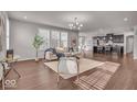 Open-concept living space features hardwood floors, large windows, and seamlessly connects to the modern kitchen at 4416 Eaglecrest Pl, Zionsville, IN 46077
