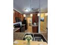 Contemporary kitchen featuring stainless steel appliances and rich wooden cabinetry at 5011 Amber Creek Pl # 205, Indianapolis, IN 46237