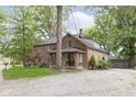 Spacious two-story brick home featuring a gravel driveway, offering a rustic and inviting exterior at 5110 S State Ave, Indianapolis, IN 46227