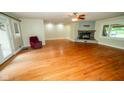 A bright living room boasts a stone fireplace and hardwood floors at 5116 W County Road 450 S, Coatesville, IN 46121