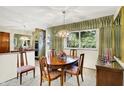 Formal dining area with wood table, upholstered chairs, and bright window view at 5236 Daniel Dr, Indianapolis, IN 46226