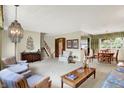 Open-concept living area with large window, adjacent dining area, and neutral carpet at 5236 Daniel Dr, Indianapolis, IN 46226