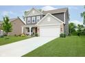 Charming two-story home with landscaped lawn and a spacious driveway leading to a two car garage at 5335 Rum Cherry Way, Indianapolis, IN 46237