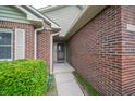 Close-up of the front entrance, showcasing brickwork and covered entryway at 5352 Steinmeier N Dr, Indianapolis, IN 46220