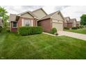 Single-story home with brick accents, a green lawn, and an attached one car garage at 5352 Steinmeier N Dr, Indianapolis, IN 46220