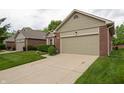 View of a single-story home with brick facade, green lawn, and an attached one car garage at 5352 Steinmeier N Dr, Indianapolis, IN 46220