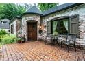 Inviting brick patio with seating and front door at 5677 Carrollton Ave, Indianapolis, IN 46220