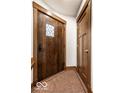 Inviting entryway with a craftsman door, unique tile flooring, and classic trim at 5677 Carrollton Ave, Indianapolis, IN 46220