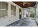 A sunroom with natural light from all the surrounding trees and easy access to the interior of the home at 6125 Winthrop Ave, Indianapolis, IN 46220