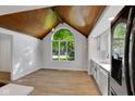 Eat-in kitchen featuring a vaulted ceiling, large window, and white countertops at 716 Royal Troon Ct, Avon, IN 46123
