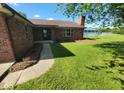 This house features a red brick exterior, a well-maintained lawn, and a welcoming entrance at 724 Iroquois St, Anderson, IN 46012