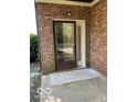 Covered entrance with a storm door, welcome mat and brick facade at 7707 River Rd # 10, Indianapolis, IN 46240