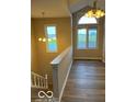 Bright living room featuring hardwood flooring, a large window and pendant lights at 7707 River Rd # 10, Indianapolis, IN 46240
