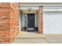Inviting entryway featuring a black front door with brick and vinyl siding at 7766 Jamestown S S Dr, Fishers, IN 46038