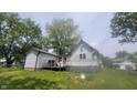 Back exterior view of the house including a wooden deck at 7879 Main St, Coatesville, IN 46121