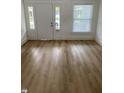 Living room featuring light wood floors, white walls, and natural light at 802 N Oakland Ave, Indianapolis, IN 46201