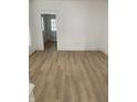 Open-concept living area with light wood flooring and white trim at 802 N Oakland Ave, Indianapolis, IN 46201