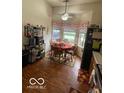 Eat-in kitchen area with oak table and chairs, large window, and vinyl wood flooring at 8457 Kousa Dr, Indianapolis, IN 46234