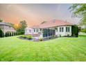 Expansive backyard with patio seating area and lush green lawn at 8703 Gordonshire Dr, Indianapolis, IN 46278