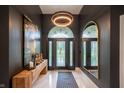 Elegant foyer with marble floors, designer lighting, and decorative mirror at 8703 Gordonshire Dr, Indianapolis, IN 46278