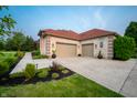 Spacious three-car garage and paved driveway, surrounded by green landscaping at 8703 Gordonshire Dr, Indianapolis, IN 46278