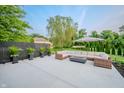 Inviting patio area featuring comfortable seating, a modern fire pit, and manicured greenery at 8703 Gordonshire Dr, Indianapolis, IN 46278