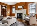 Cozy living room with a fireplace, hardwood floors, and neutral-toned furniture for comfortable living at 948 N Layman Ave, Indianapolis, IN 46219