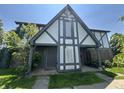 Two-story townhouse with light gray trim and covered entranceway with brick accents at 9794 Kingscross Ct, Indianapolis, IN 46235