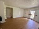 View of a sunlit living room, featuring wood floors and access to the exterior at 9794 Kingscross Ct, Indianapolis, IN 46235