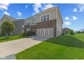 Charming two-story home with attached two-car garage and well-maintained front lawn at 1026 Sorrell Pass, Greenwood, IN 46143