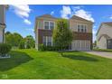 Spacious home featuring brick accents, siding, a two-car garage, and green lawn at 1026 Sorrell Pass, Greenwood, IN 46143