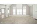 Bright living room with high ceilings, large windows, and neutral carpet at 10555 Serra Vista Pt, Fishers, IN 46040