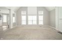 Bright living room with tall windows, neutral paint, and plush carpet flooring at 10555 Serra Vista Pt, Fishers, IN 46040