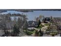 Stunning lakeside home with lush greenery and mature trees at 11931 Promontory Ct, Indianapolis, IN 46236