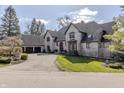 Charming brick home with a manicured lawn and mature trees at 11931 Promontory Ct, Indianapolis, IN 46236